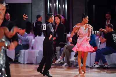 Dancesport competitor: Male dancer: black long-sleeved shirt and black trousers