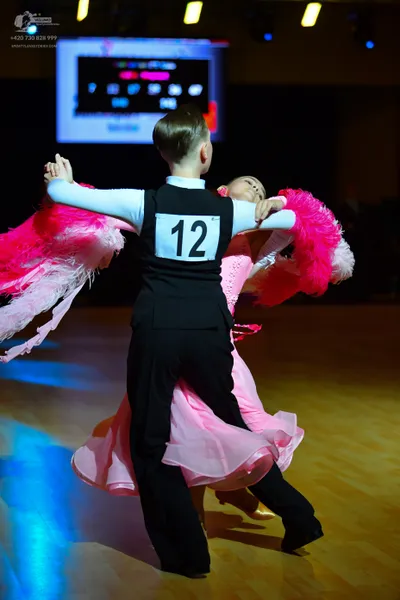Dancesport competitor #12: Male dancer: white long-sleeved shirt with a black vest and black trousers