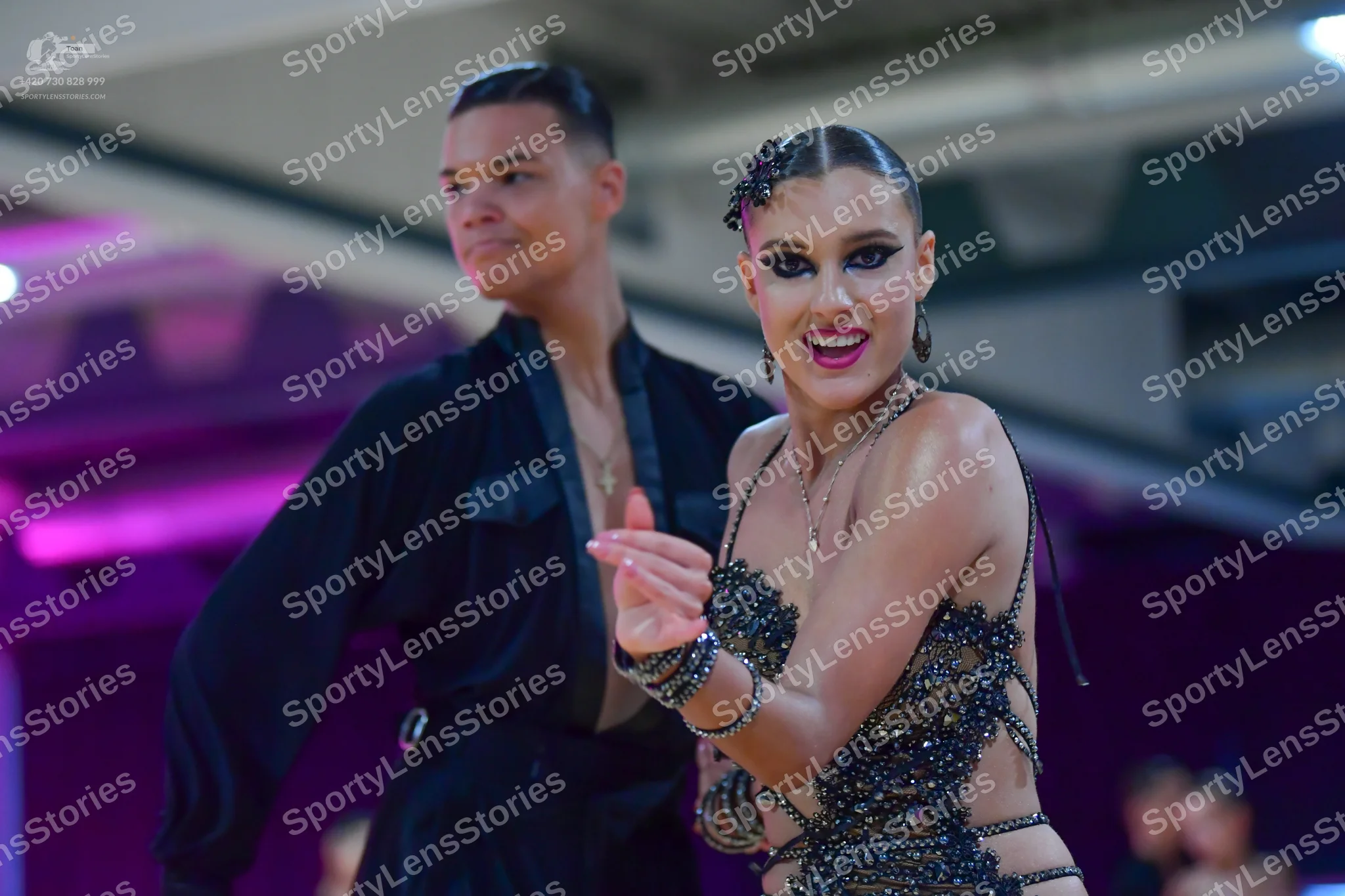 Dancesport competitor: Male dancer: black long-sleeved shirt with a darker fabric panel on the chest