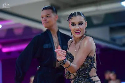 Dancesport competitor: Male dancer: black long-sleeved shirt with a darker fabric panel on the chest