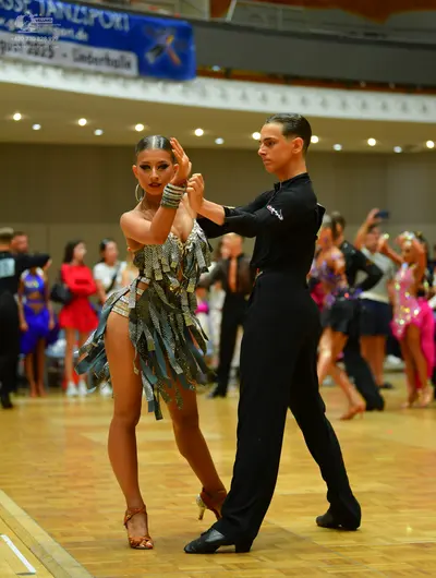 Dancesport competitor: Main female dancer: silver/grey Latin dress with metallic fringe