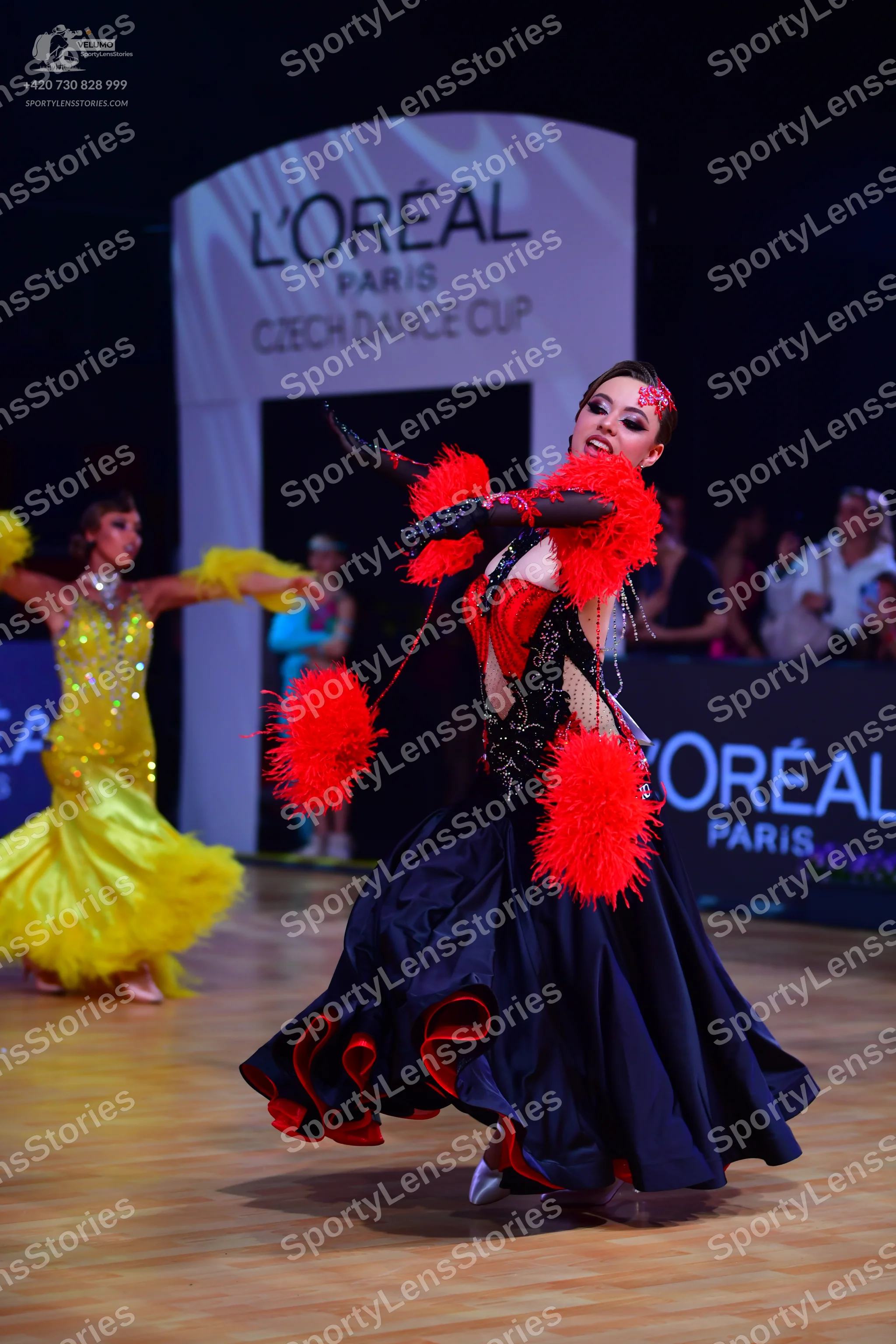 Dancesport competitor: Female dancer 1: yellow ballroom dress with sequins and a voluminous skirt