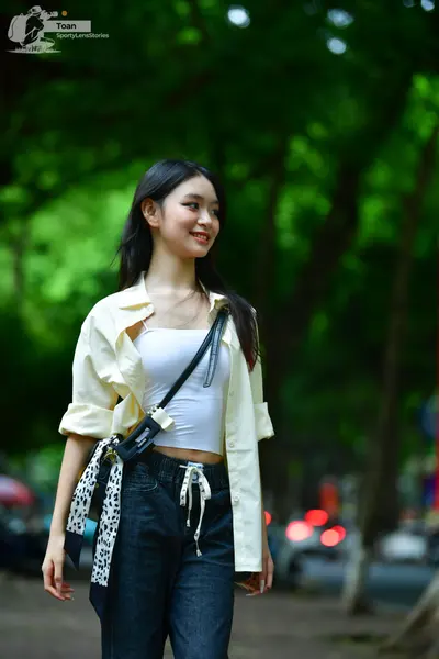 Dancesport competitor: Female dancer: white/off-white long-sleeved open shirt, white crop top, dark den