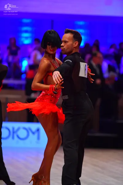 Dancesport competitor: Male dancer: black long-sleeved shirt and black trousers