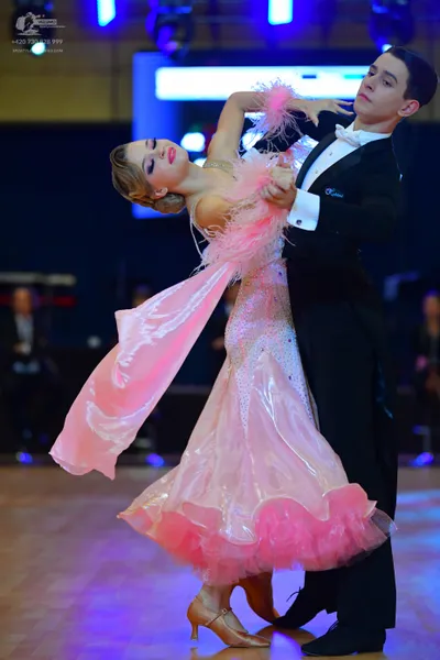 Dancesport competitor: Male dancer: black tuxedo with a white shirt and white bowtie