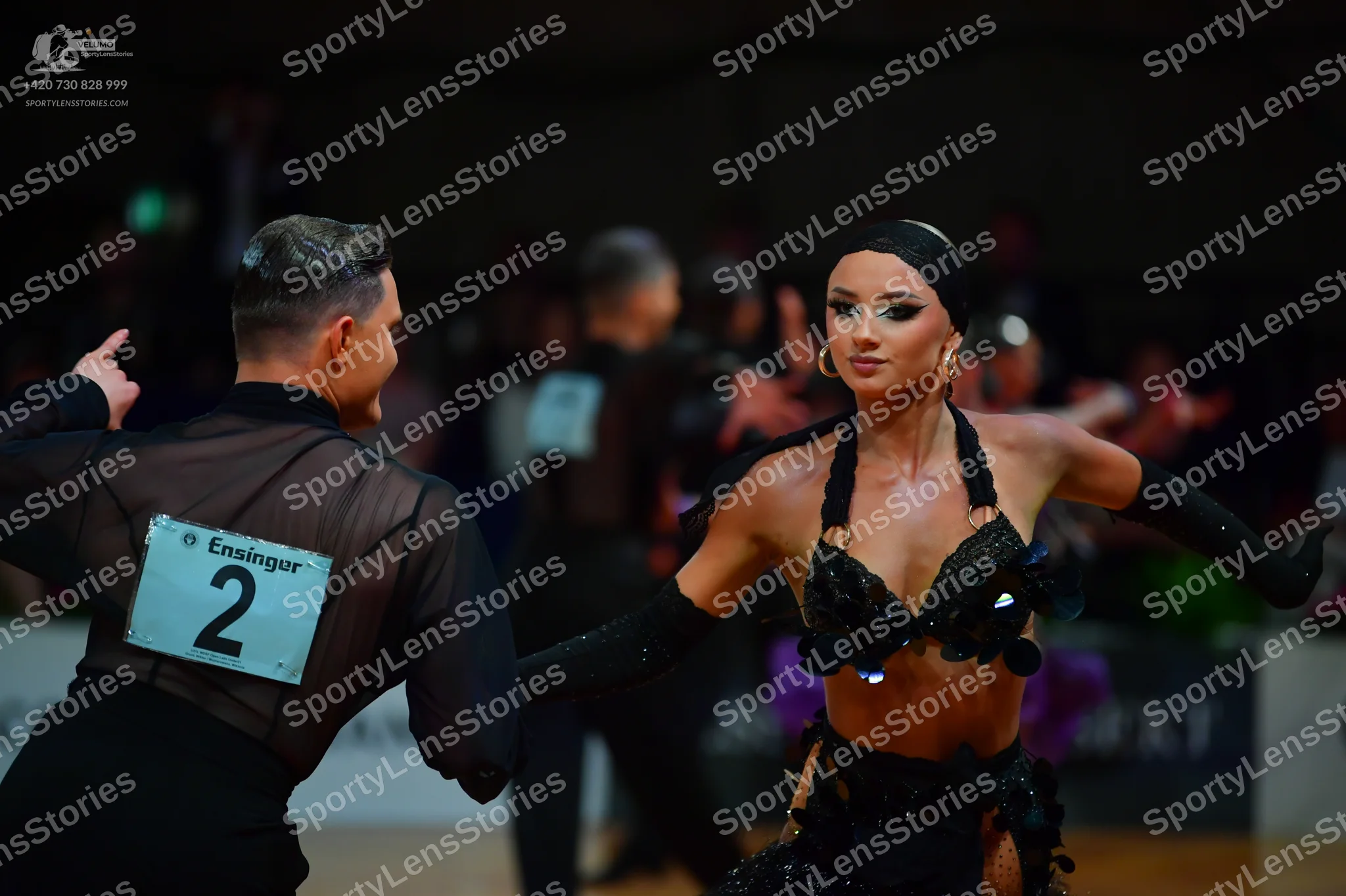 Dancesport competitor: Male dancer: black sheer long-sleeved top and black trousers