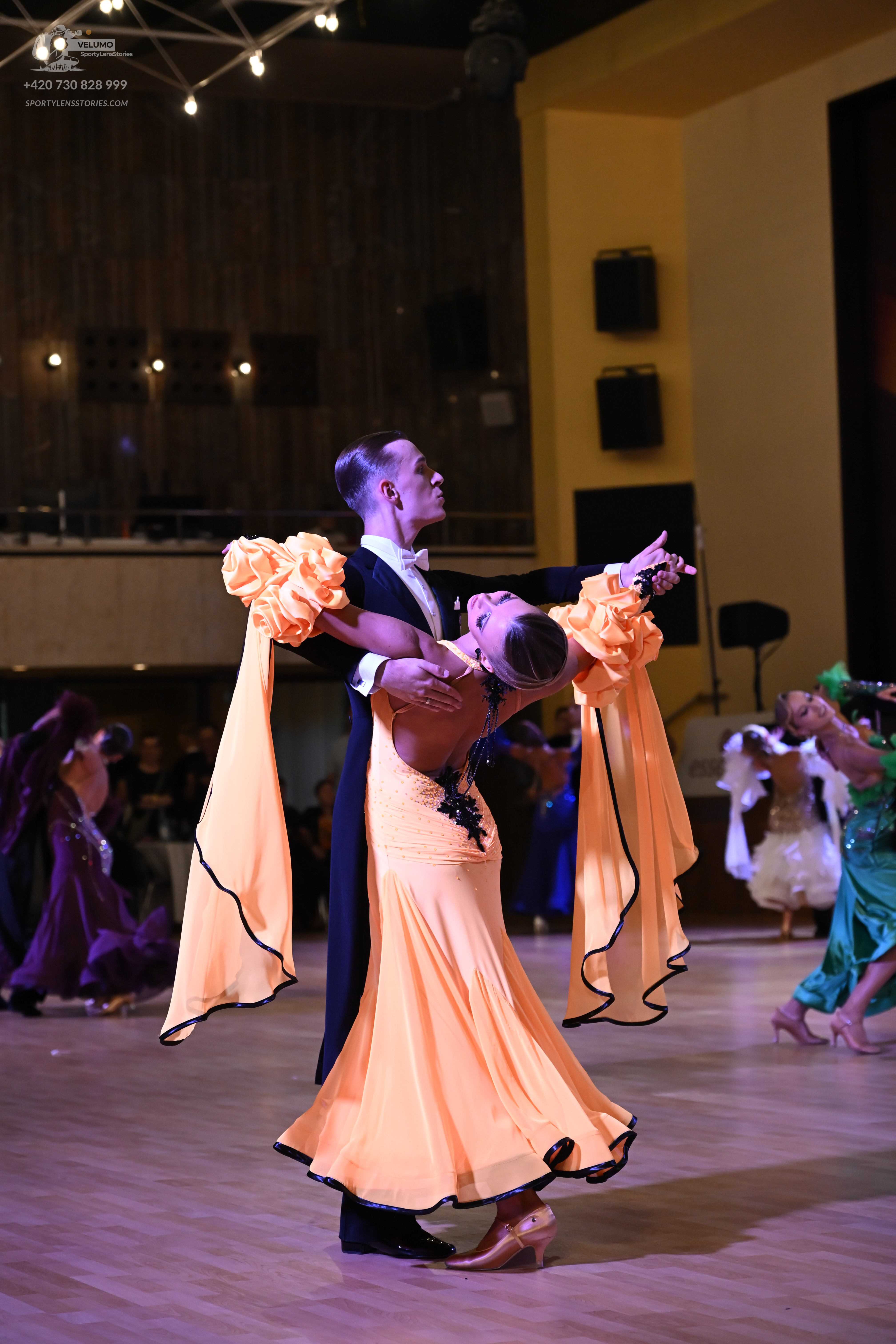 Dancesport competitor: ** Black tail suit with a high collar and sequin lapels