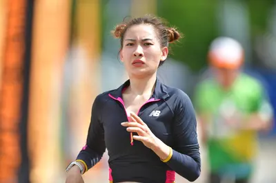 Marathon runner: Runner 1: black long-sleeved top with pink accents and a white logo, white wrist