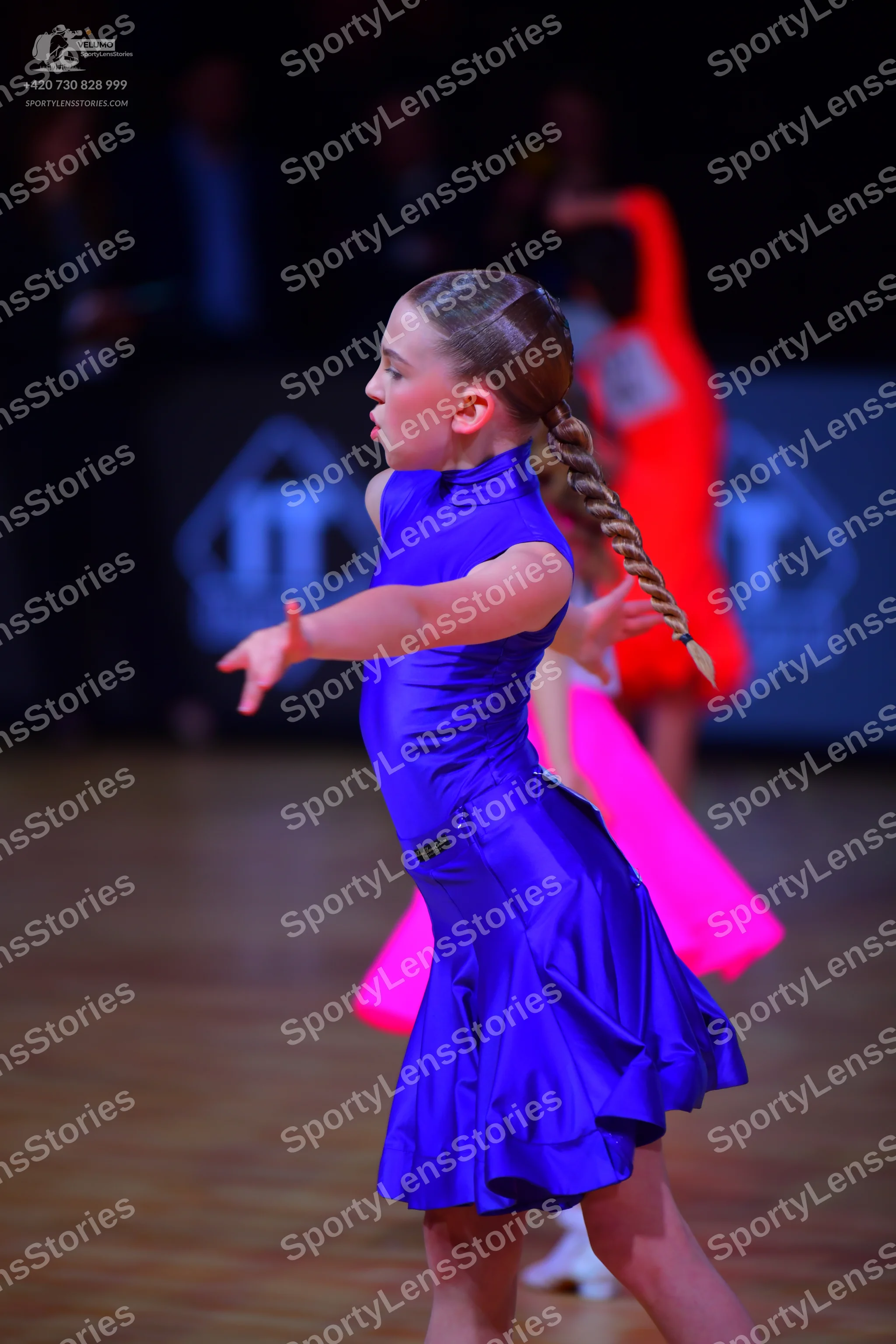 Dancesport competitor: Female dancer: blue satin latin dress with a flared skirt