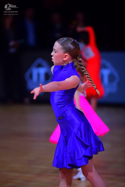 Dancesport competitor: Female dancer: blue satin latin dress with a flared skirt