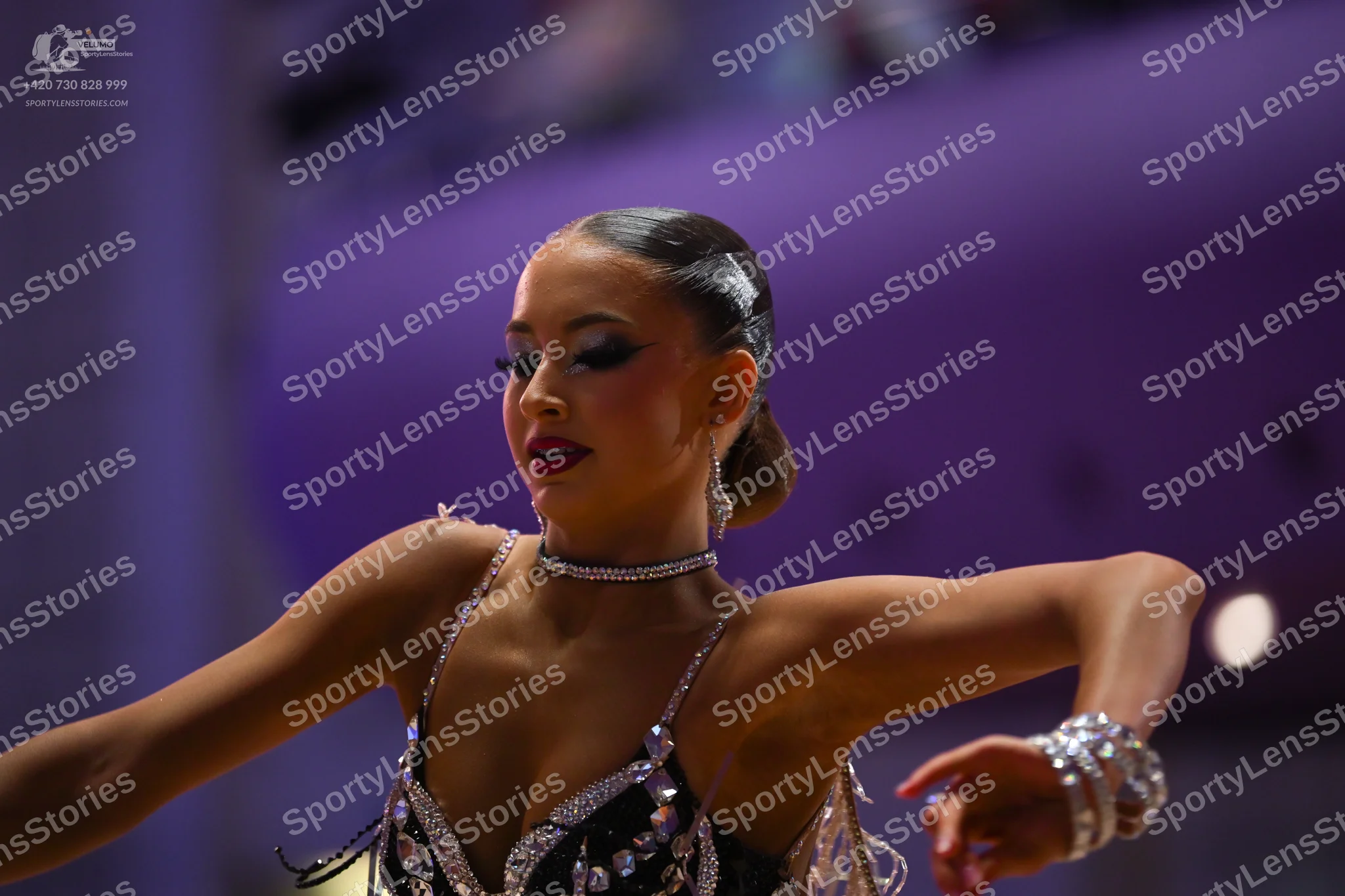Dancesport competitor: Female dancer: Black latin dance top embellished with large clear rhinestones, f