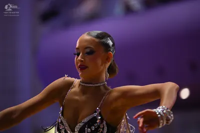 Dancesport competitor: Female dancer: Black latin dance top embellished with large clear rhinestones, f