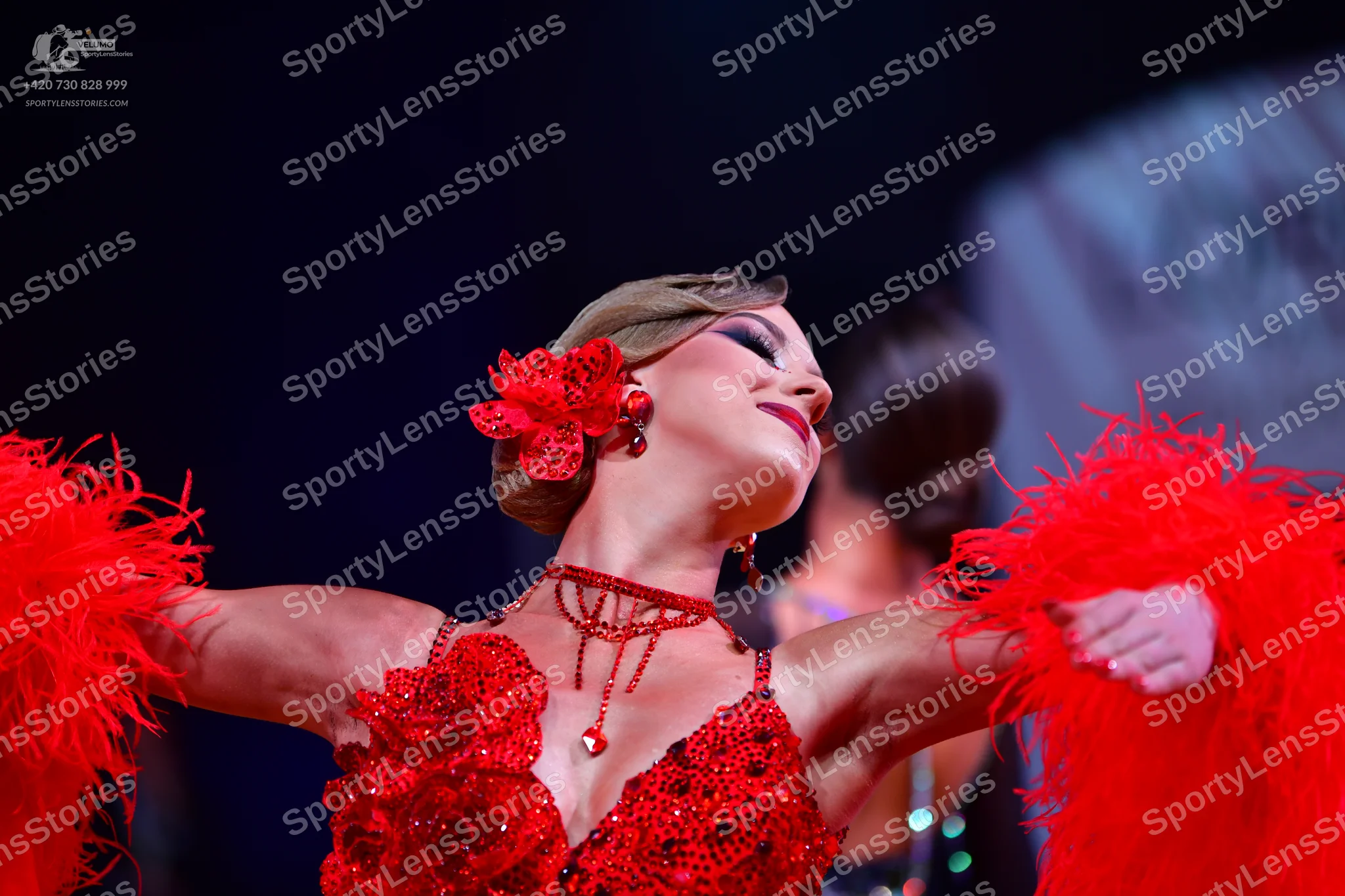 Dancesport competitor: Female dancer: red Latin dance dress with sequin floral appliques and large red