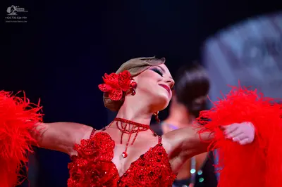 Dancesport competitor: Female dancer: red Latin dance dress with sequin floral appliques and large red 