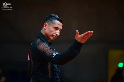 Dancesport competitor: Male dancer: black long-sleeved dance shirt with sequin/crystal embellishments o