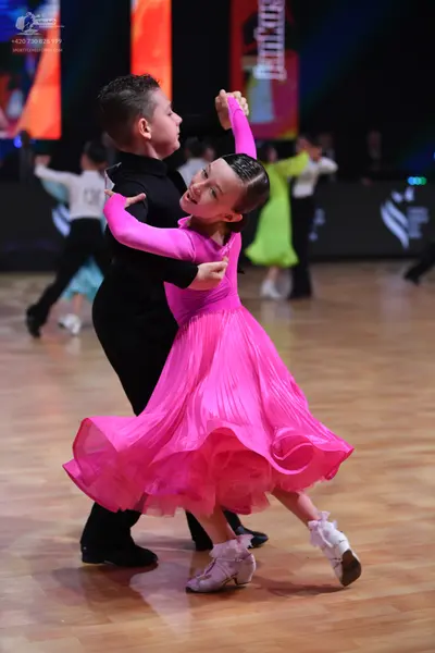 Dancesport competitor: Male dancer: black long-sleeved shirt and black trousers