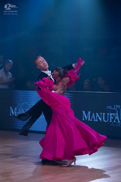 Dancesport competitor: Male dancer: black suit with a white shirt and white bow tie