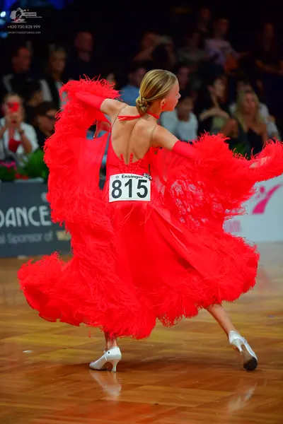 Dancesport competitor #815: Female dancer: red latin dress with voluminous layers of fringe or feathers and 