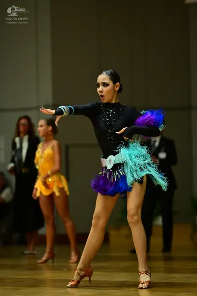 Dancesport competitor: Main dancer: black long-sleeved Latin dress with a sequined neckline, a white se