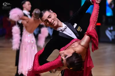 Dancesport competitor: Male dancer (foreground): black suit with a white shirt and bowtie