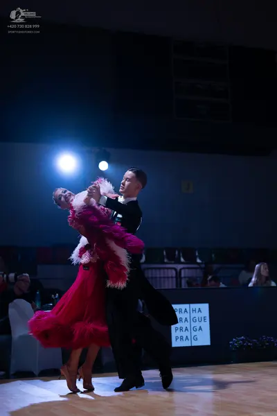 Dancesport competitor: Male dancer: black suit with a white shirt and black dance shoes