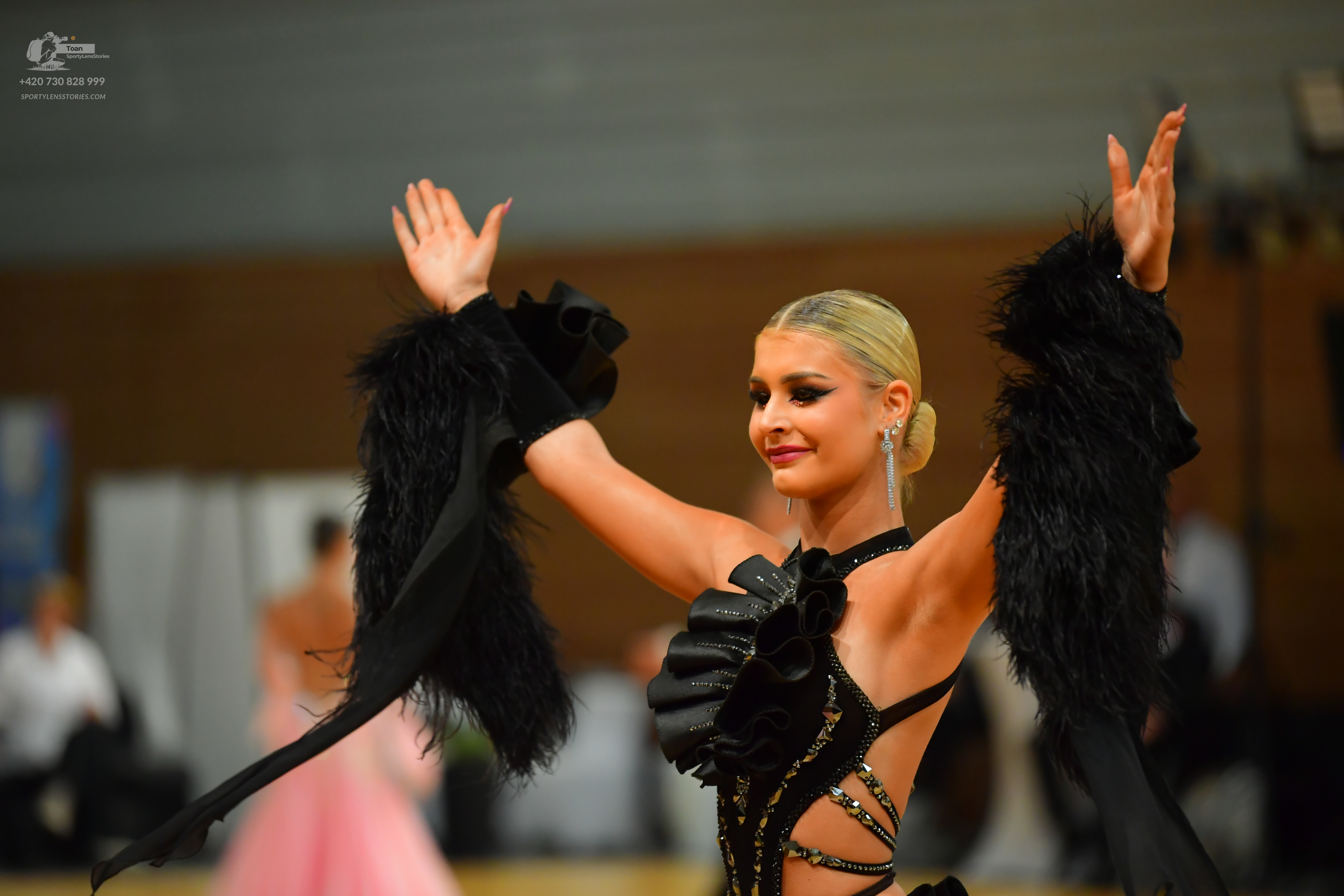 Dancesport competitor: ** Black Latin Dress
*   **Fabric:** Primarily satin with heavy embellishment
