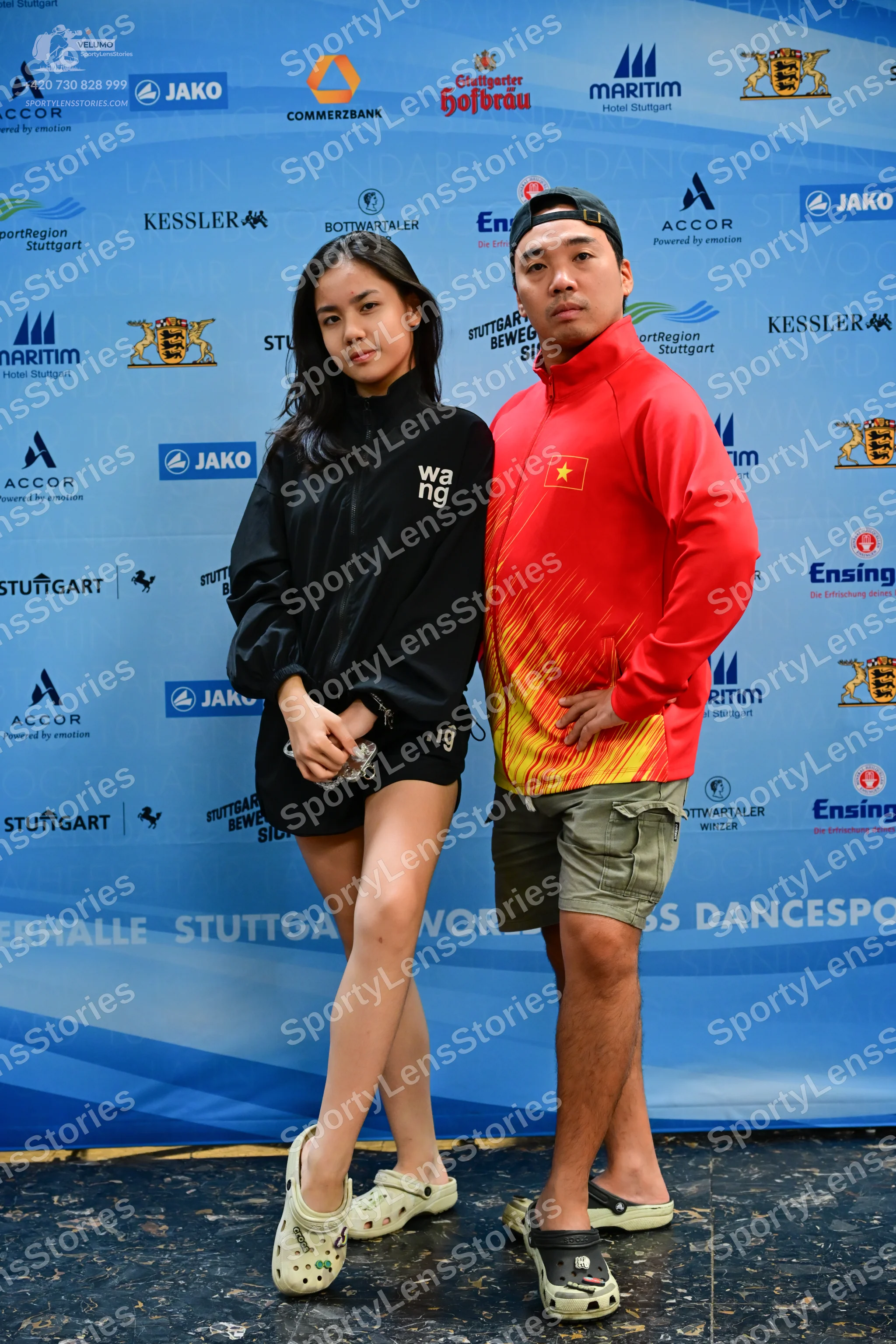 Dancesport competitor: Male dancer: red and yellow gradient long-sleeved jacket, khaki shorts, and blac