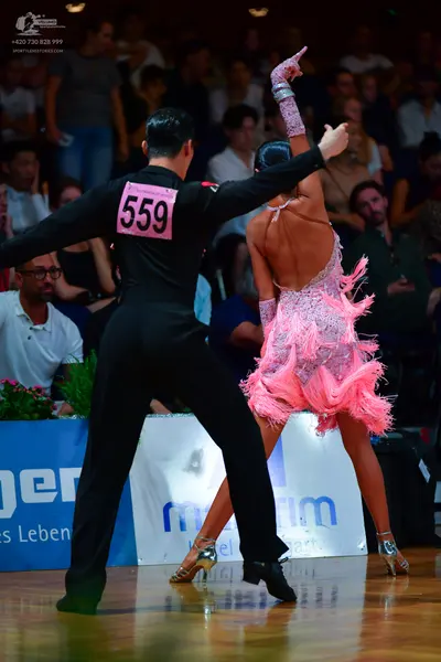 Dancesport competitor: Male dancer: black long-sleeved shirt and black trousers