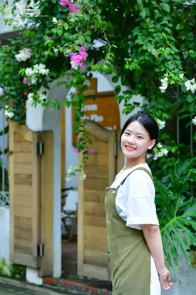 Dancesport competitor: The person is wearing a white short-sleeved t-shirt and an olive green apron