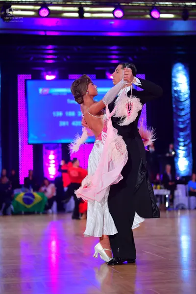 Dancesport competitor: Male dancer: black ballroom suit with a white shirt