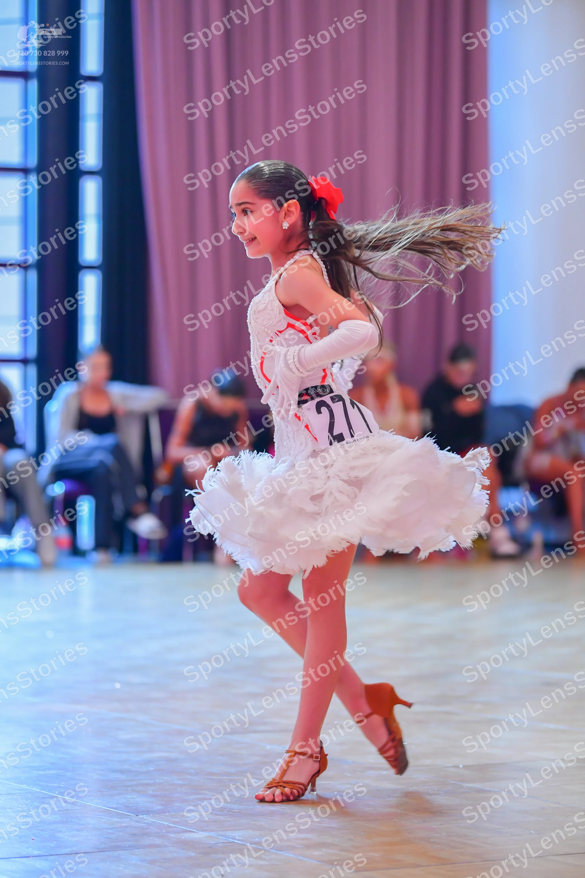 Dancesport competitor #271: Female dancer: white latin dress with a ruffled, multilayered skirt and a white 