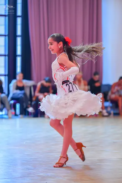 Dancesport competitor #271: Female dancer: white latin dress with a ruffled, multilayered skirt and a white 