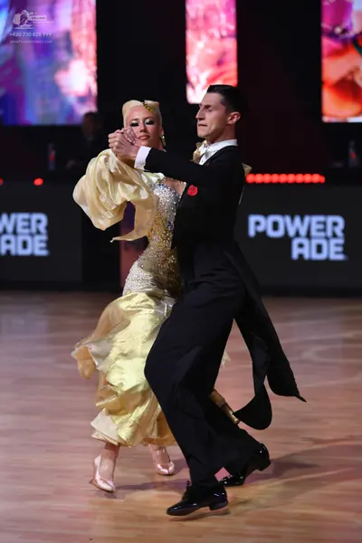 Dancesport competitor: Male dancer: black tailcoat with satin lapels, white shirt, black bowtie, black 