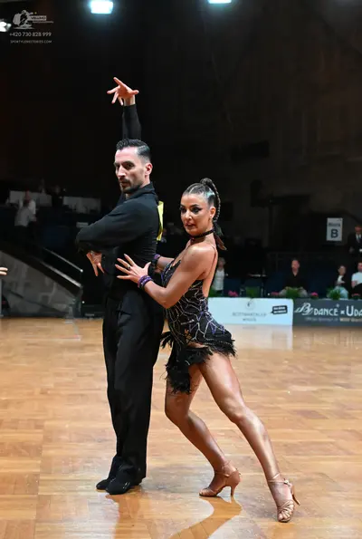 Dancesport competitor: Male dancer: black long-sleeved shirt and black trousers