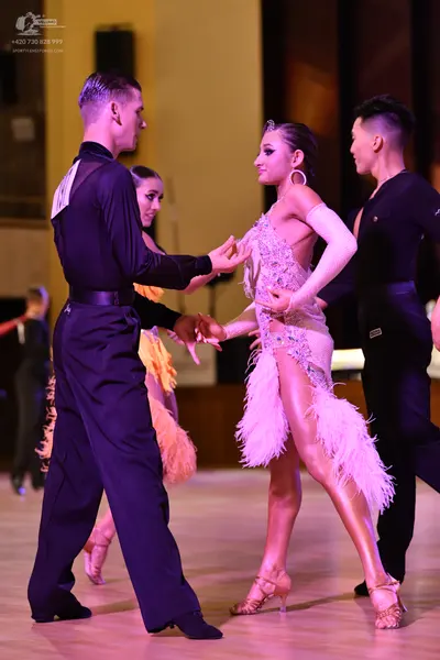 Dancesport competitor: ** Black tailsuit
*   **Fabric:** Likely satin or a similar smooth fabric, with 