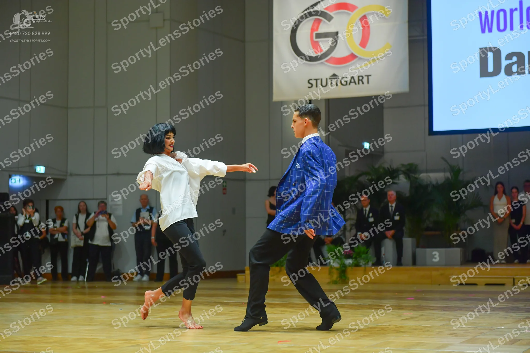 Dancesport competitor: Male dancer: blue patterned suit jacket and black trousers