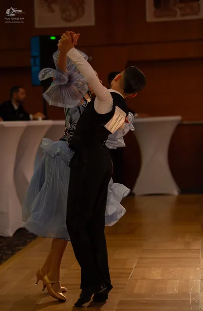 Dancesport competitor #73: Male dancer: black waistcoat, white long-sleeved shirt, and black trousers