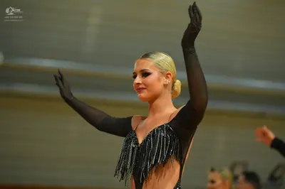 Dancesport competitor: ** Red Latin dress
*   **Fabric:** Appears to be a satin or crepe fabric, possib