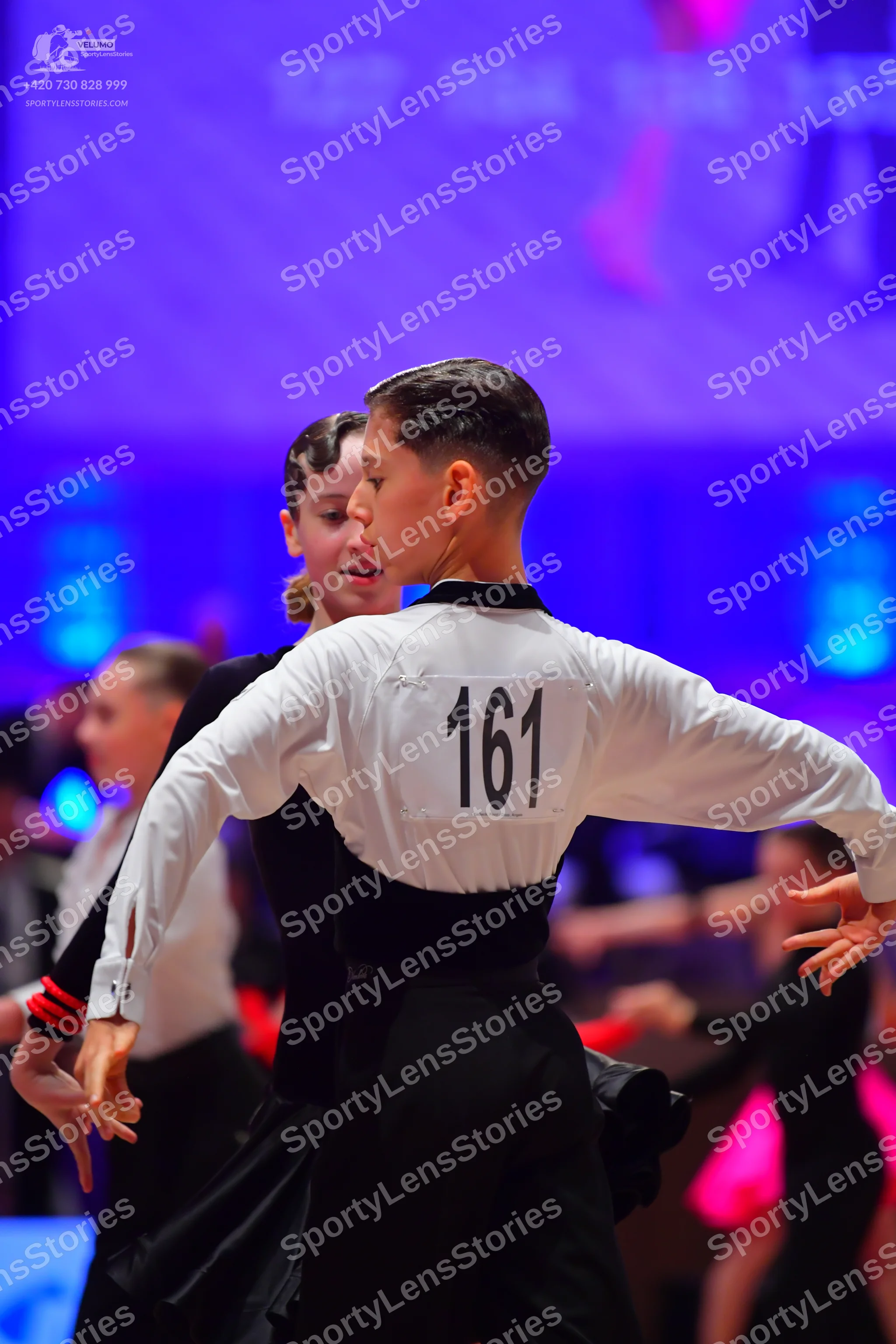 Dancesport competitor: Male dancer: white long-sleeved shirt with a black waistband and black trousers