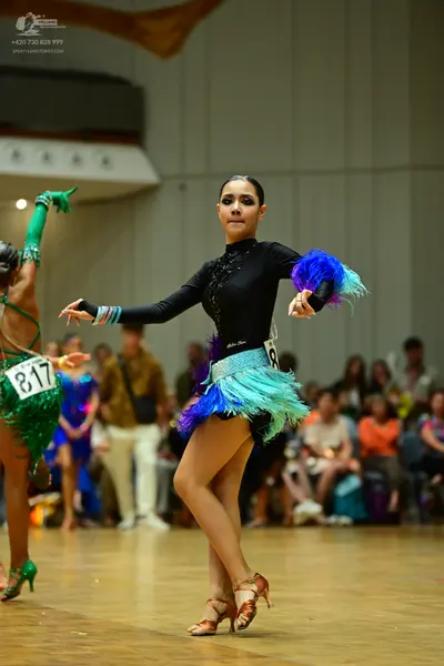 Dancesport competitor #817: Female dancer in green: green Latin dress with sequins and fringe