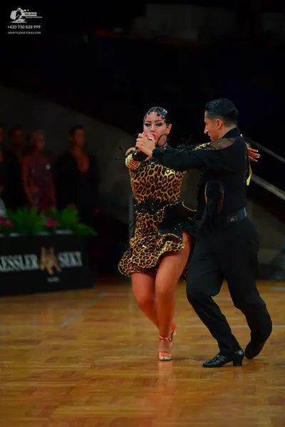 Dancesport competitor: Female dancer: leopard print Latin dress with black sequin embellishments