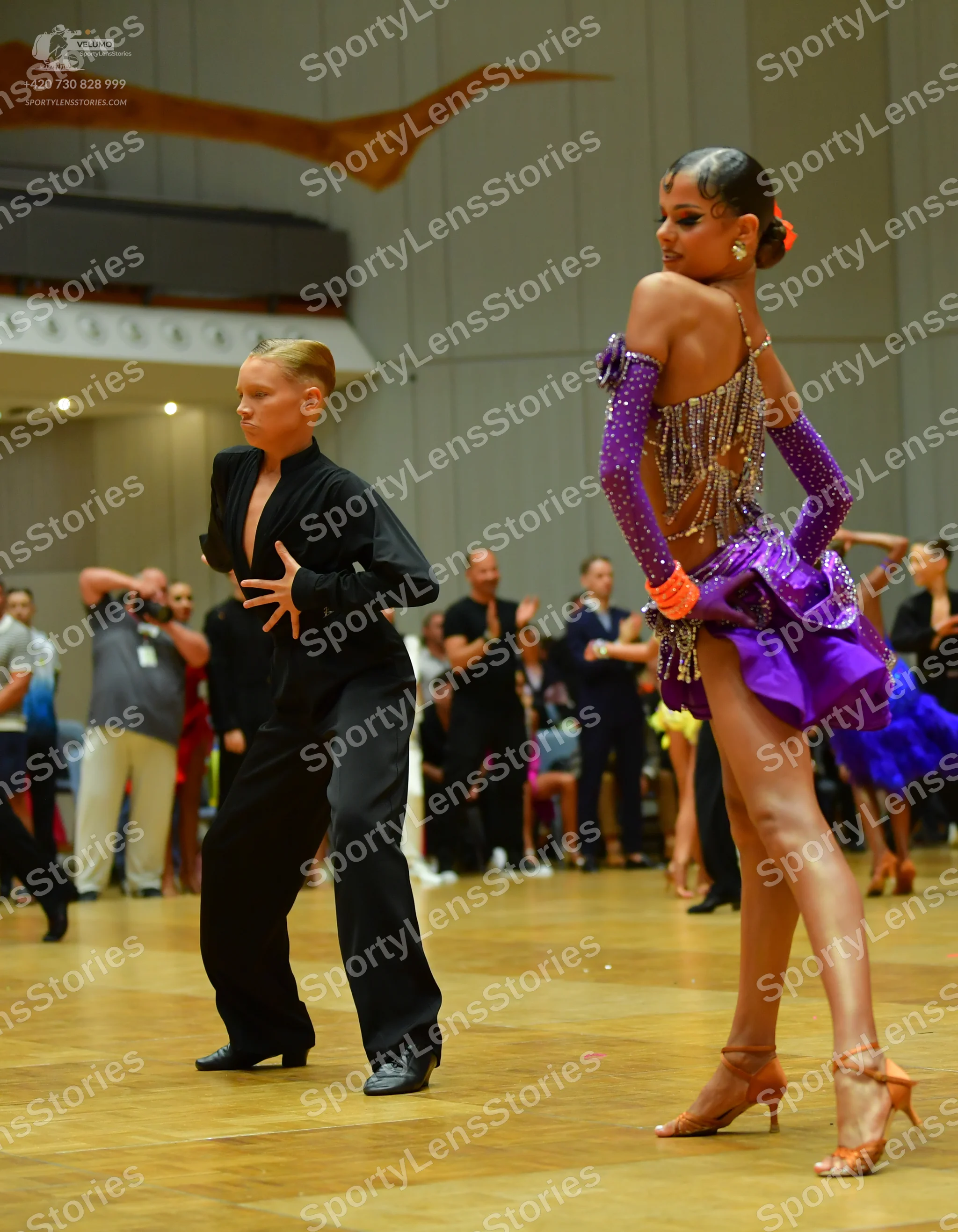 Dancesport competitor: Male dancer: black long-sleeved top with a deep V-neck and black trousers