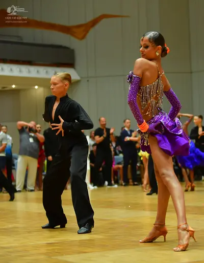 Dancesport competitor: Male dancer: black long-sleeved top with a deep V-neck and black trousers