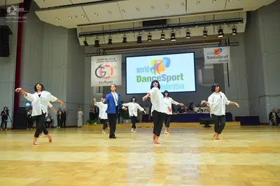 Dancesport competitor: Male dancer: blue suit jacket, white shirt, and black trousers
