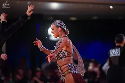 Dancesport competitor #528: Female dancer: nude-colored Latin costume with intricate silver and white sequin