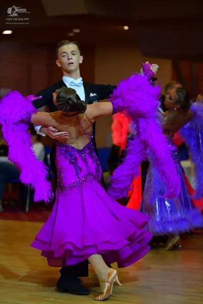 Dancesport competitor: Male dancer: black suit with a white shirt and white bow tie