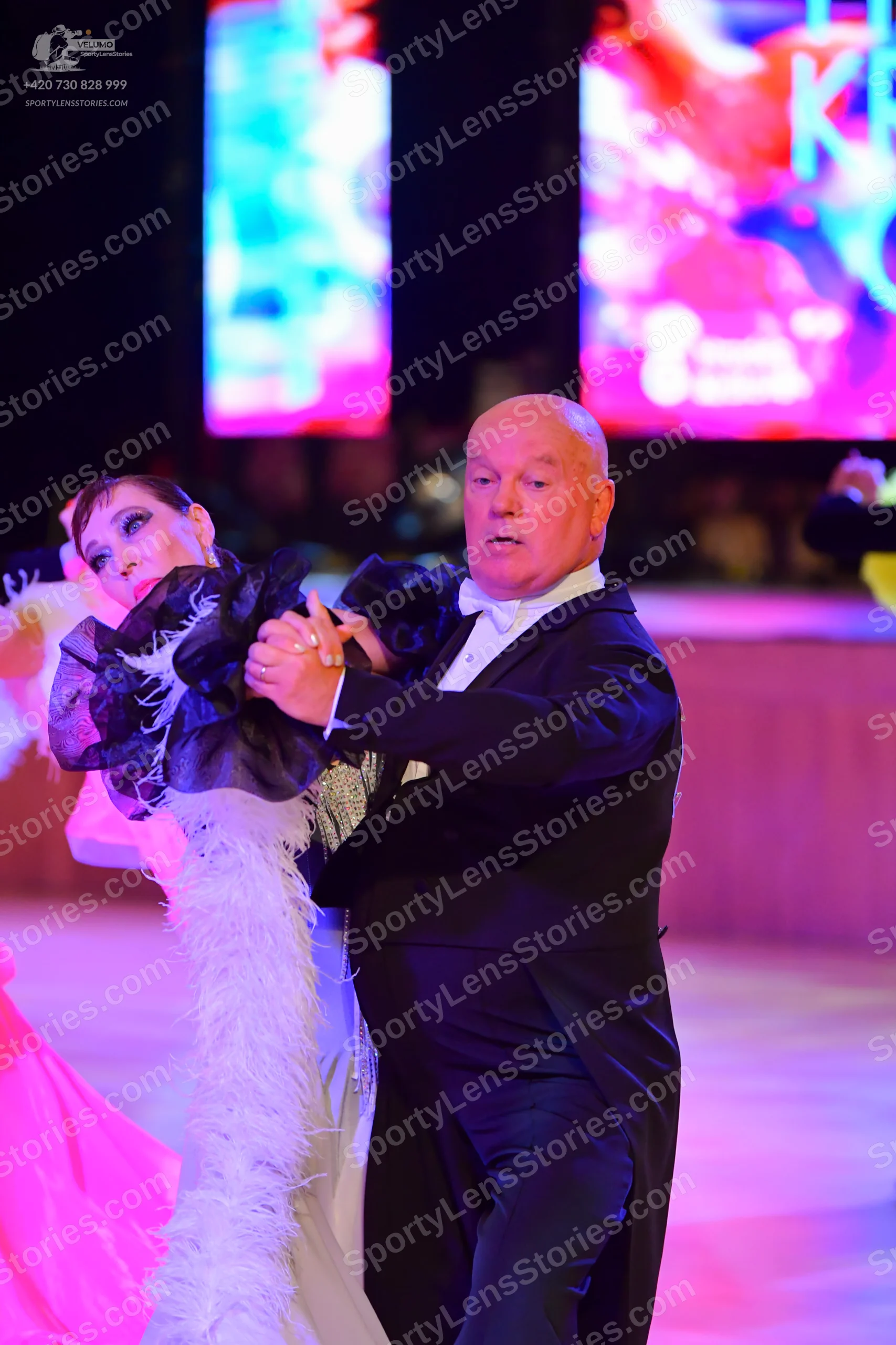 Dancesport competitor: Male dancer: black suit with a white shirt and white bow tie