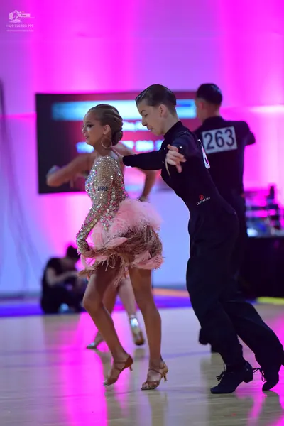 Dancesport competitor #263: Female dancer: pink sequined latin dress with feather trim