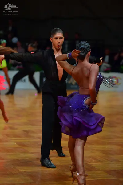 Dancesport competitor: Male dancer: black long-sleeved shirt with vertical ribbing and black trousers