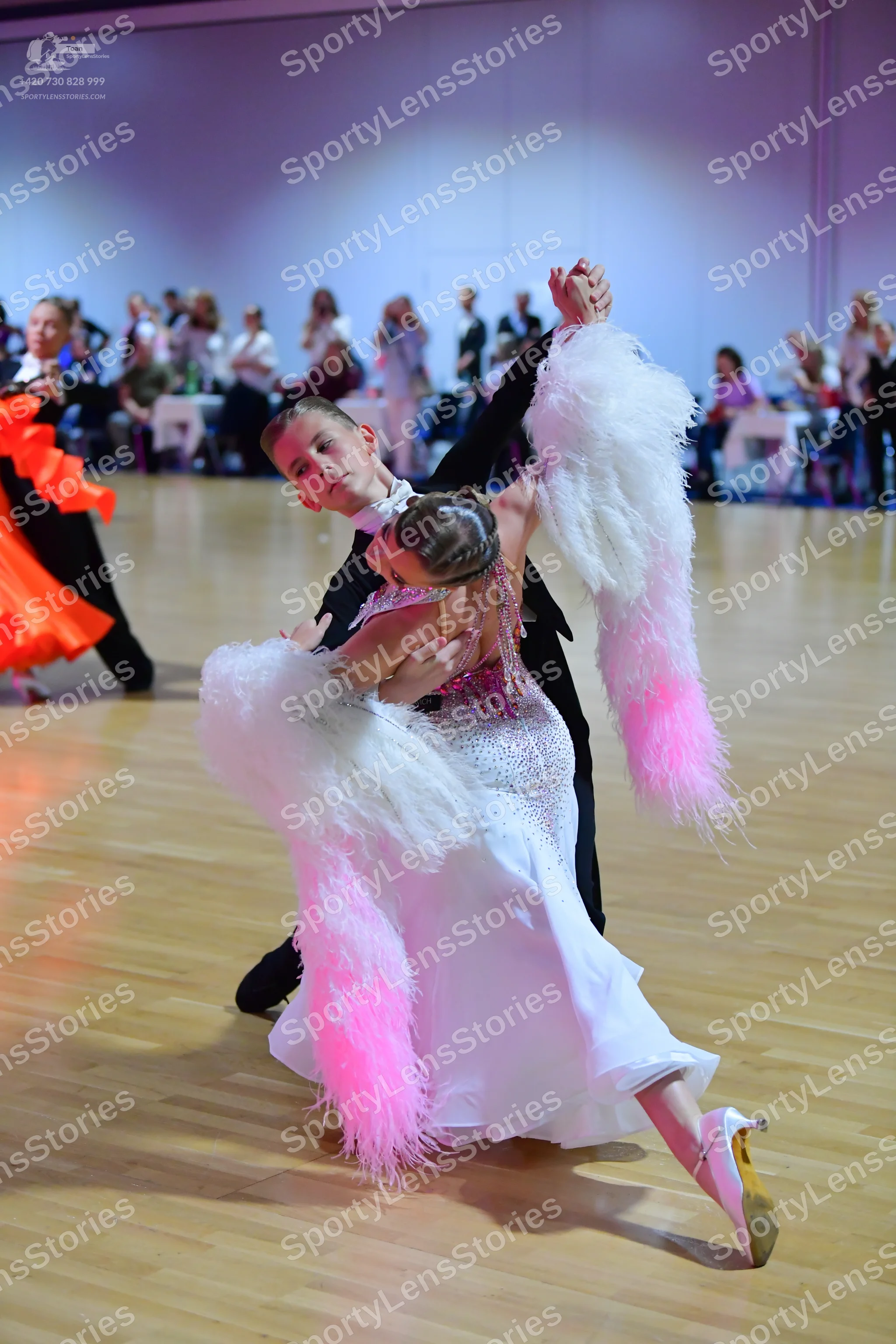 Dancesport competitor: Main male dancer: black suit with a white shirt and white bowtie